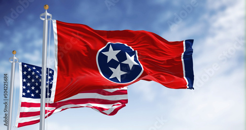 The Tennessee state flag waving along with the national flag of the United States of America photo