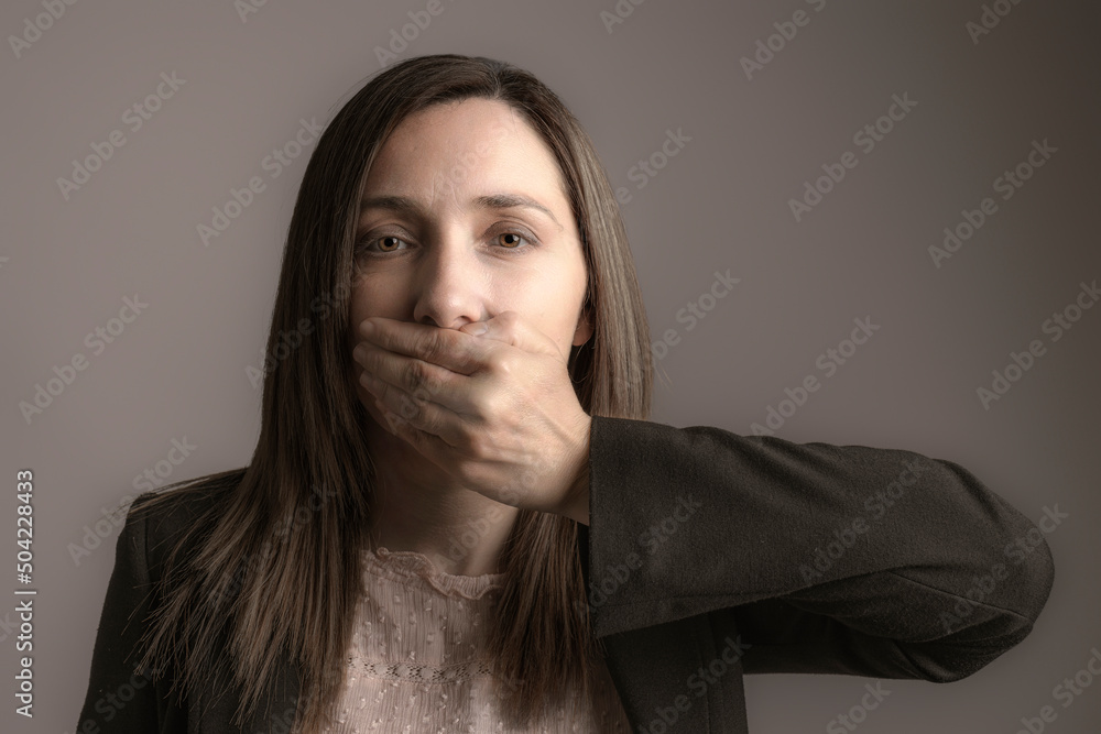 woman covering her mouth with one hand. woman covering her mouth with one hand.