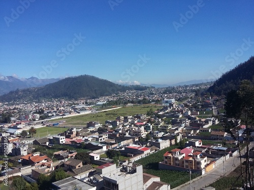 The city of Banos at the foot of the mountain in the clouds. View from the height. Banos