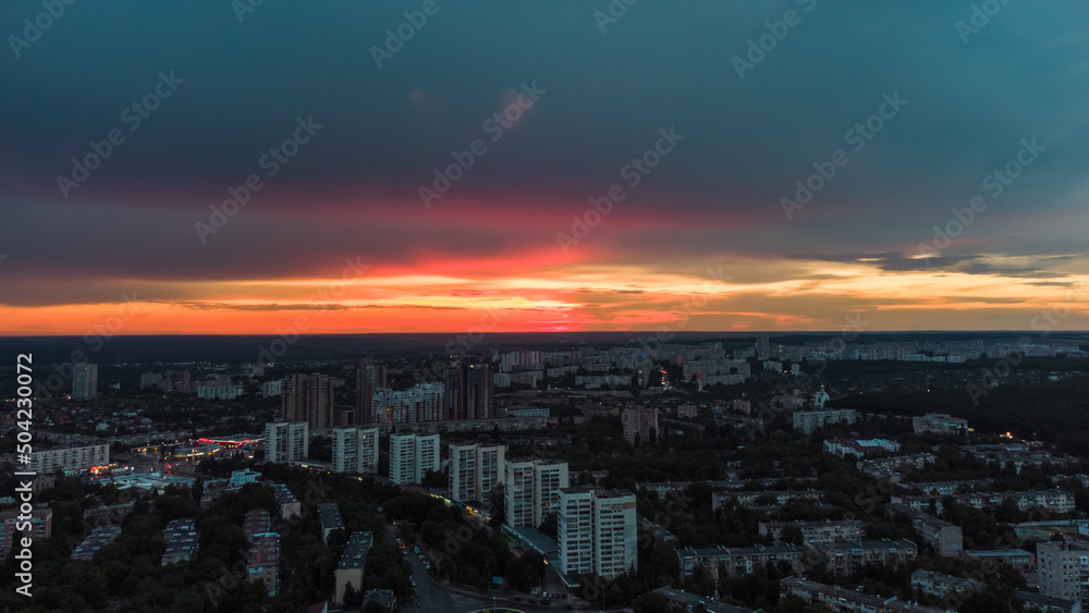 Epic aerial vivid sunset view above residential district. 23 serpnia Pavlovo Pole, Kharkiv city, Ukraine. Majestic evening cloudscape and streets