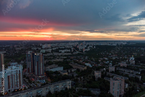 Epic vibrant sunset aerial view in city residential multistory district. Pavlovo Pole, Kharkiv Ukraine. Evening cloudscape and houses