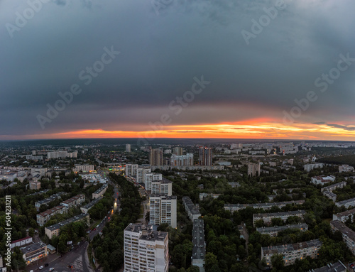 Epic sunset aerial urban view in city residential district. 23 serpnia, Pavlovo Pole, Kharkiv, Ukraine. Majestic evening skyscape, cloudscape and streets