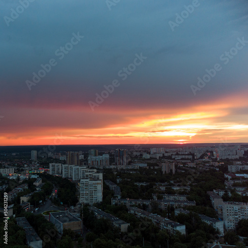 Epic vivid sunset above city residential district, aerial view. Pavlovo Pole, Kharkiv Ukraine. Majestic evening skyscape, cloudscape and houses