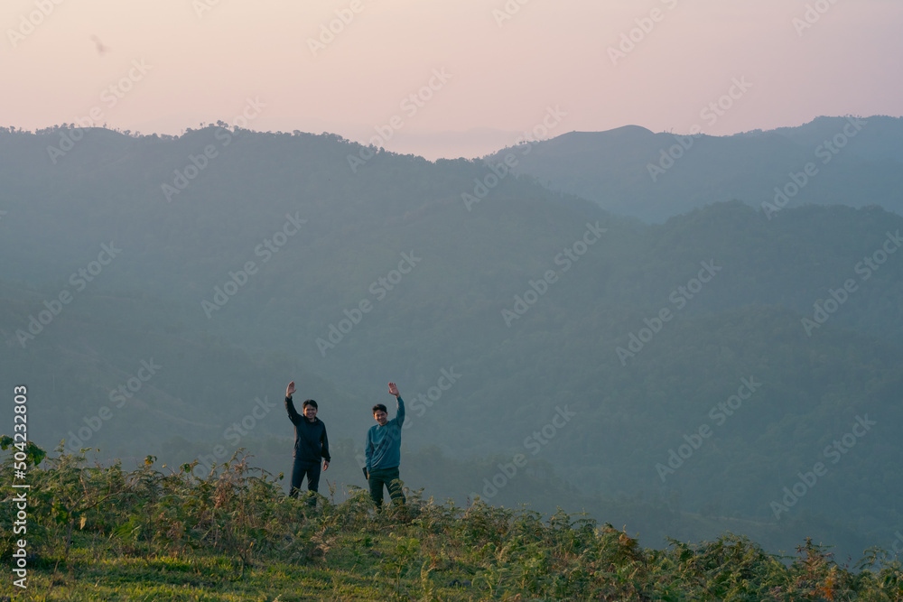 group of hiker man relax with wellbeing and happy feeling on top of mountain