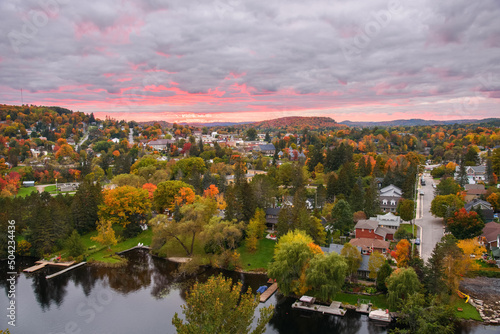 Beautiful town surrounded by hills covered in deciduous forest at the peak of autumn colours at dusk. Huntsville  ON  Canada.
