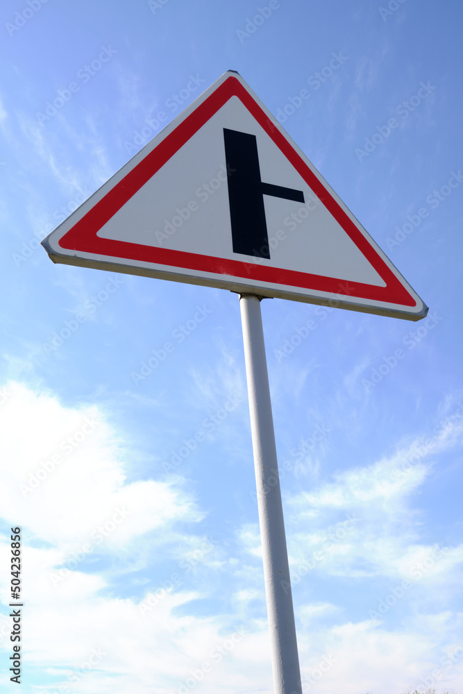 Road sign warning turn from main road blue sky background. Road sign warning turn from main road blue sky background.