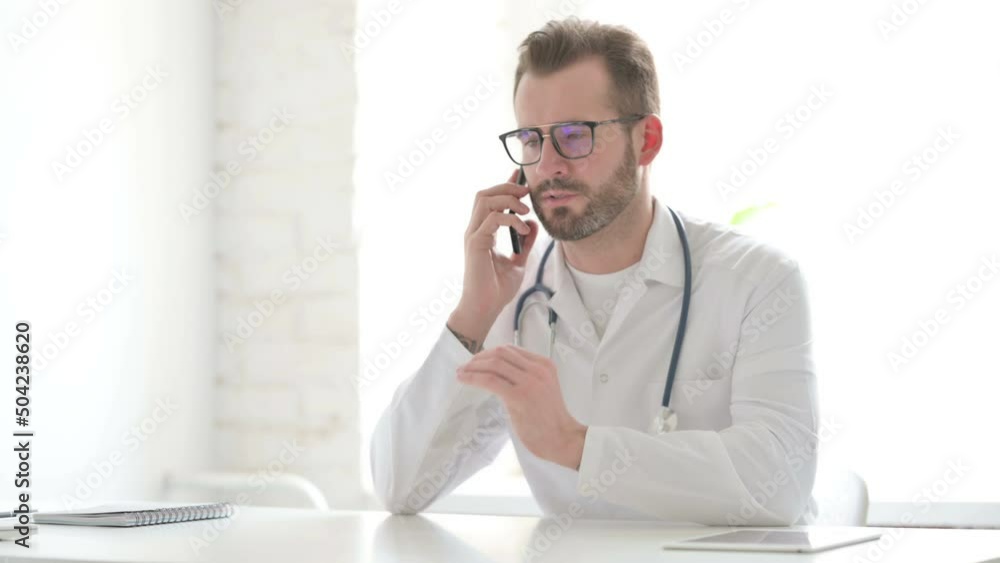 Doctor Talking on Phone in Office Doctor Talking on Phone in Office