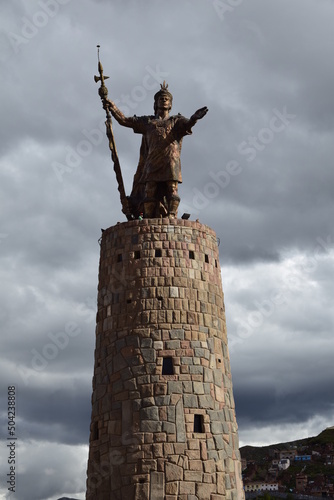 Image of a golden Inca's sculpture in a monument. Traditional icon in Cusco Peru