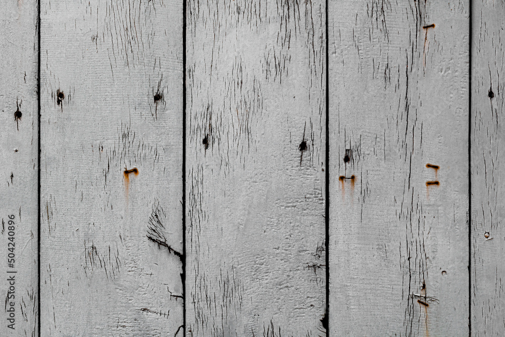 Texture of stained vertical planks facade. Old dirty rough siding of gnarled surface rural country wooden paneling. Messy aged laths. Rustic grungy ranch lumber fence of hard boards for barn design Texture of stained vertical planks facade. Old dirty rough siding of gnarled surface rural country wooden paneling. Messy aged laths. Rustic grungy ranch lumber fence of hard boards for barn design