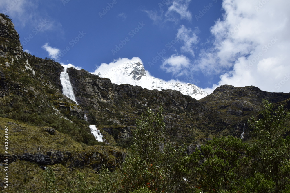 A beautiful waterfall falls from a high mountain, on the way to Lagoon 69. Huascaran National Park in the Sands of Peru