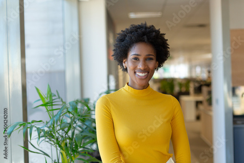 Portrait of happy beautiful african american young female advisor at modern workplace