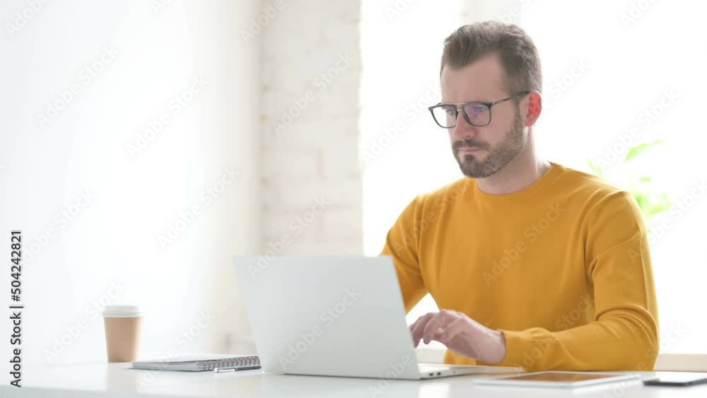 Man Working on Laptop in Office Man Working on Laptop in Office