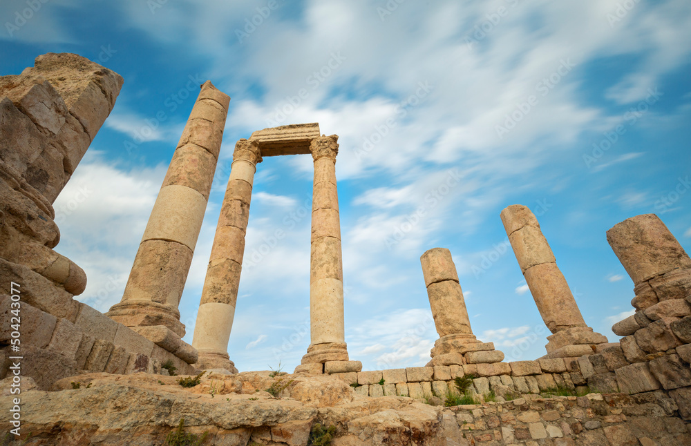 unsurpassed view of the ruins of the temple of Hercules on the top of the mountain of the Amman citadel against the background of a blue sky with clouds