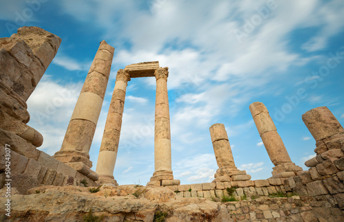 unsurpassed view of the ruins of the temple of Hercules on the top of the mountain of the Amman citadel against the background of a blue sky with clouds photo