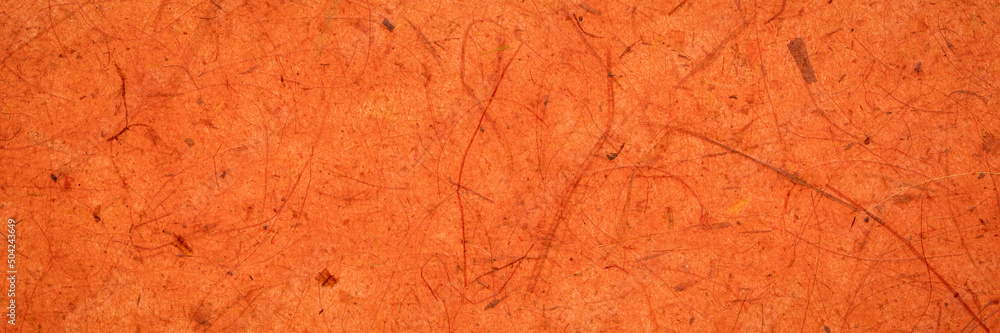 background of amber and orange backlit, handmade, mulberry paper with leaf and fine inclusions, panoramic web banner background of amber and orange backlit, handmade, mulberry paper with leaf and fine inclusions, panoramic web banner