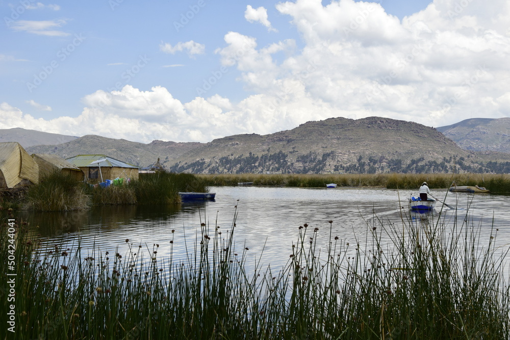 Floating islands near Puno city, Buildings and houses made of straw on the floating islands of Lake Titicaca. Puno, Peru Floating islands near Puno city, Buildings and houses made of straw on the floating islands of Lake Titicaca. Puno, Peru