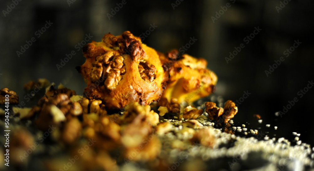 cupcakes lie on a dark glass table scattered with nuts delicious next to grains and walnuts. High quality photo cupcakes lie on a dark glass table scattered with nuts delicious next to grains and walnuts. High quality photo