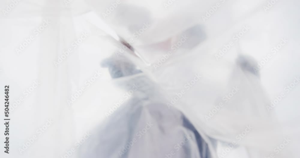 Low angle view of african american man putting garbage in a plastic bag Low angle view of african american man putting garbage in a plastic bag