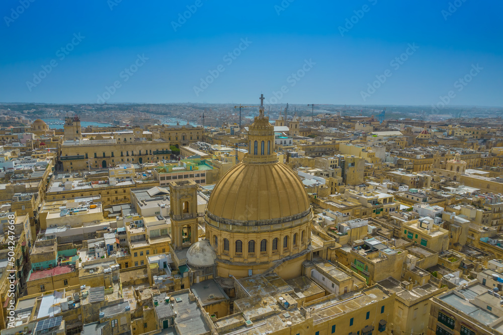 Aerial view of Basilica Lady of Mount Carmel church, St. Paul's Cathedral in the old town of Valetta, Malta. Roofs of Malta capital from above on a sunny day