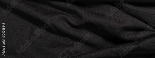 Banner from wavy fabric texture. Black background