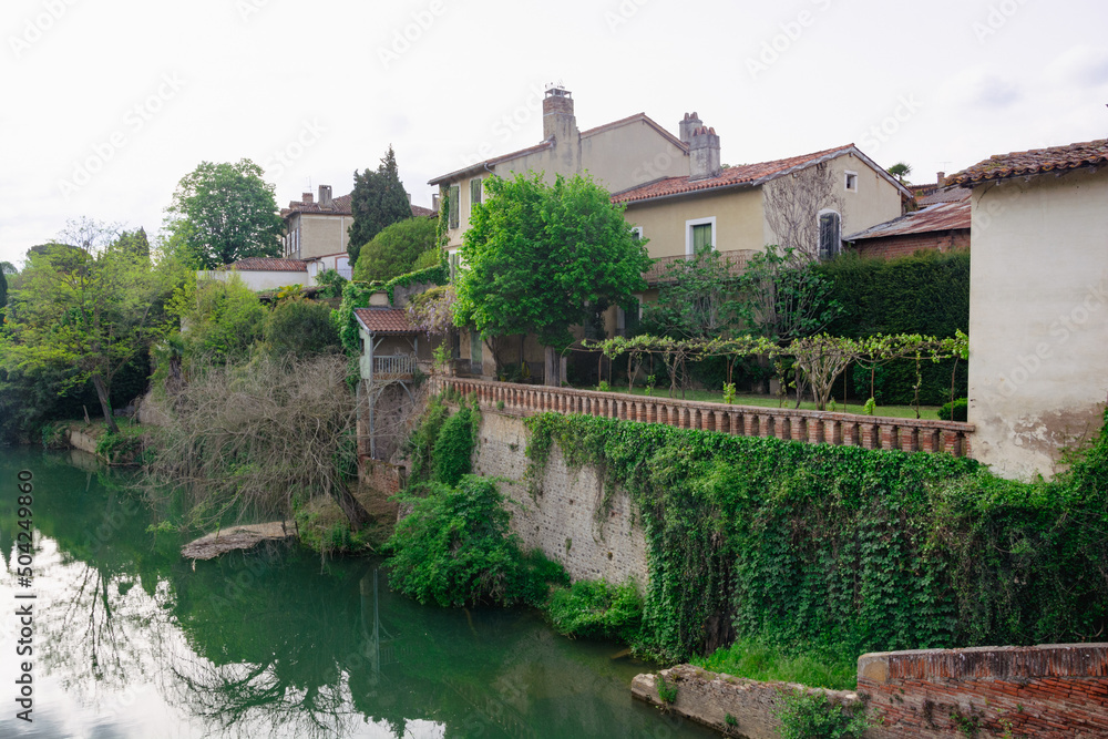 Veiw at the medieval street with a flowers in the in Rieux-Volvestre, France in summer