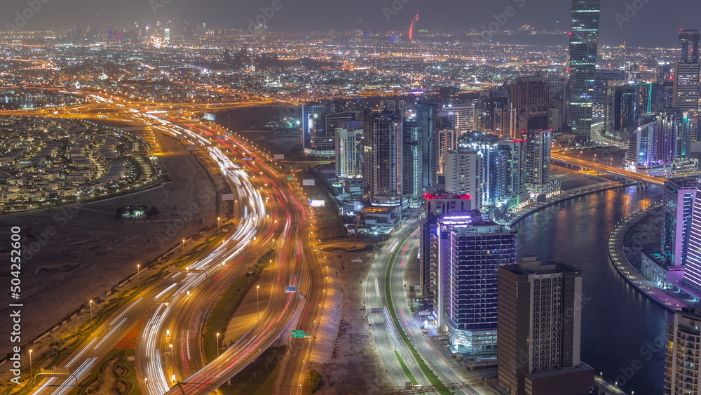 Skyline with modern architecture of Dubai business bay towers night timelapse. Aerial view
