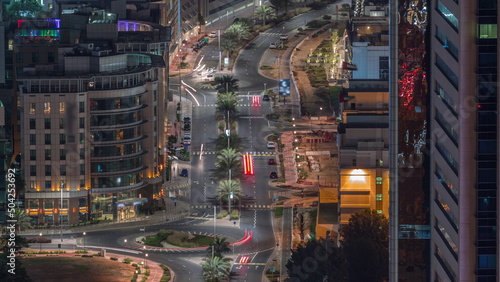 Aerial view of a road intersection in a big city night timelapse in Media city