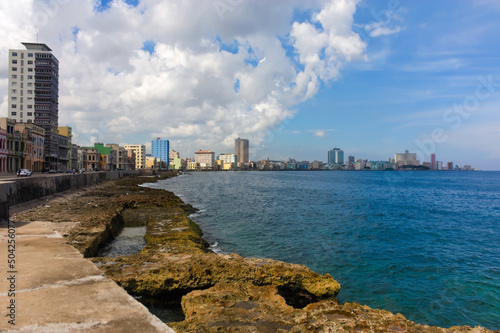 Promenade in Havana, Cuba, the Malecon, overlooking the turquoise Caribbean Sea in the Atlantic Ocean. Image was taken on a bright warm summer day.