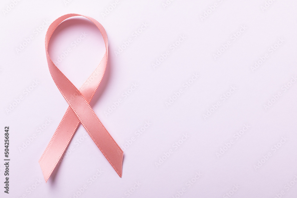 Overhead view of pink breast cancer awareness ribbon isolated against white background, copy space Overhead view of pink breast cancer awareness ribbon isolated against white background, copy space