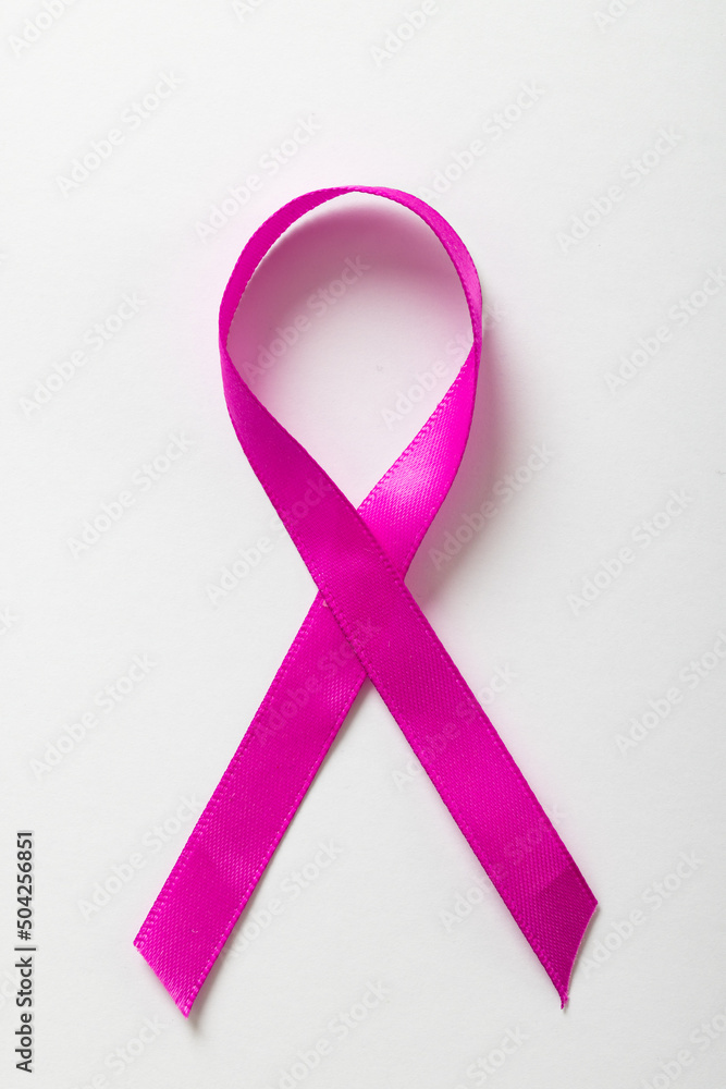 Overhead view of pink breast cancer awareness ribbon isolated on white background, copy space Overhead view of pink breast cancer awareness ribbon isolated on white background, copy space