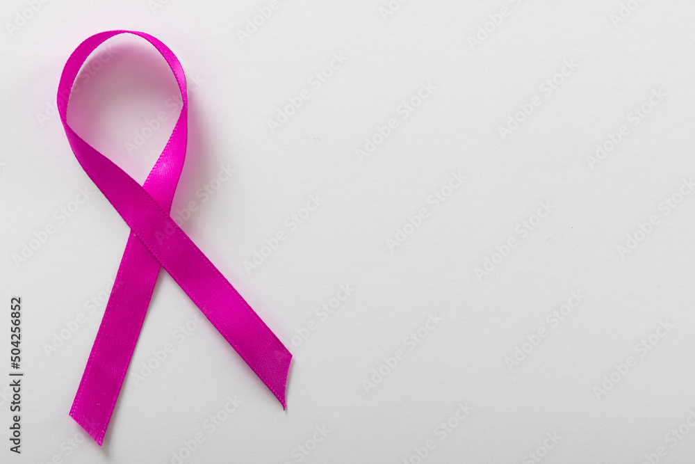 Overhead view of pink breast cancer awareness ribbon isolated over white background, copy space Overhead view of pink breast cancer awareness ribbon isolated over white background, copy space