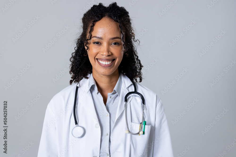 Portrait of happy african american mid adult female doctor with stethoscope against white background Portrait of happy african american mid adult female doctor with stethoscope against white background