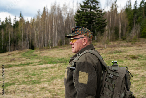 Old Hunter in the woods with his dog. Male hunter hunting with his hunting dog outdoors. German wirehaired pointer. Hunter with his shotgun in middle of nature. © Василь Івасюк