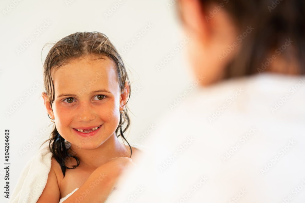 Happy beautiful young girl in front of mirror after the shower. Happy beautiful young girl in front of mirror after the shower.