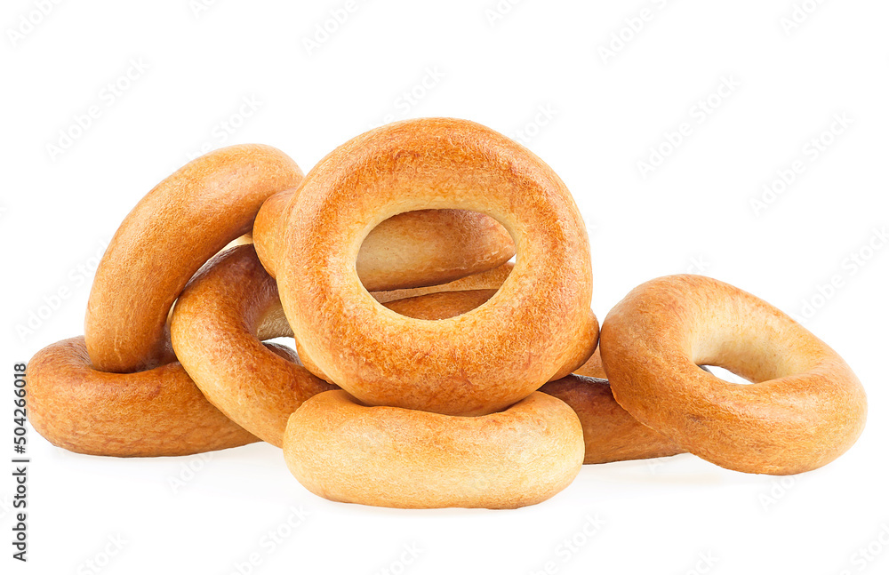 Delicious bread rings isolated on a white background. Pile of fresh bagels. Delicious bread rings isolated on a white background. Pile of fresh bagels.