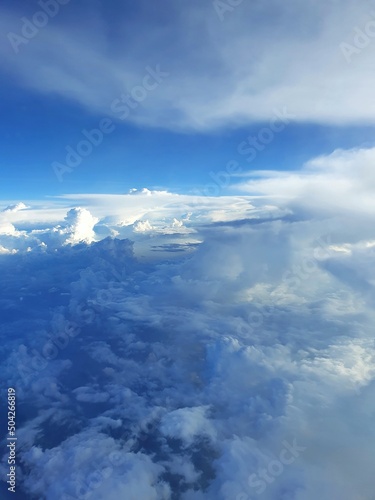 clouds above the clouds, aircraft window view, flying in the sky
