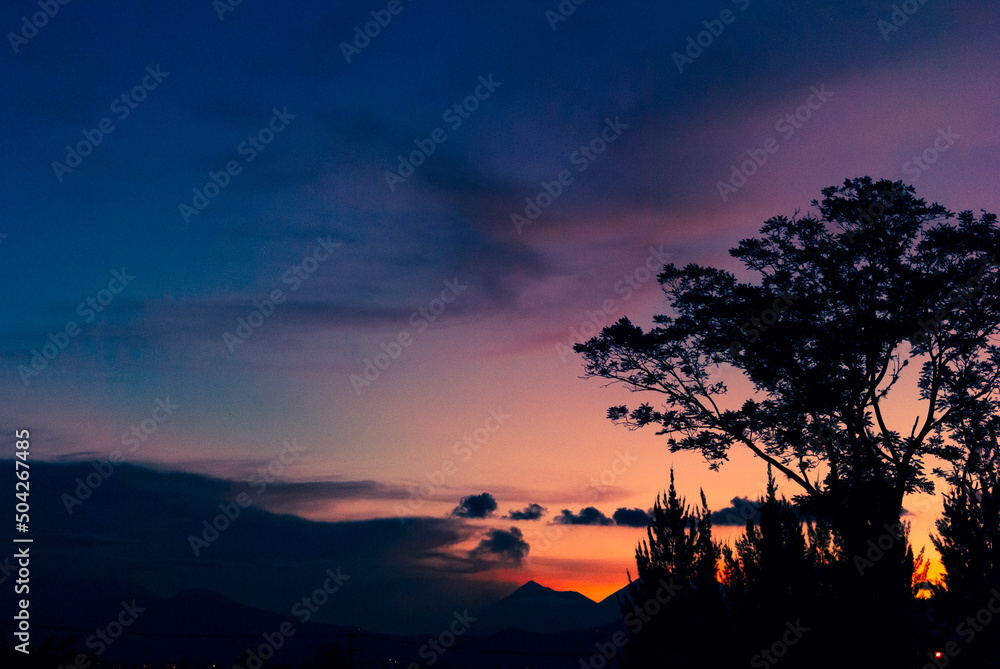 Silhouette of volcano and mountains from Guatemala City, sunset and spectacular colors in space.