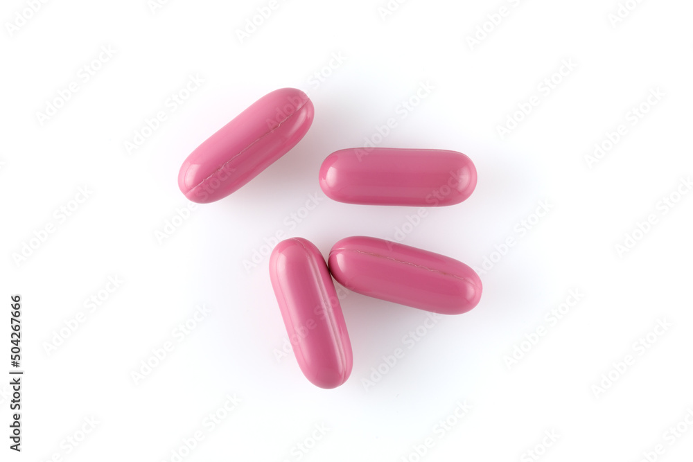 Pink capsules with medical drugs or supplements isolated on white background, top view. Pink capsules with medical drugs or supplements isolated on white background, top view.