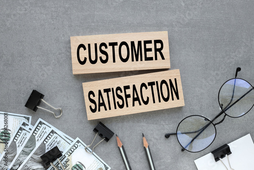 customer satisfaction text on wooden blocks on gray background photo