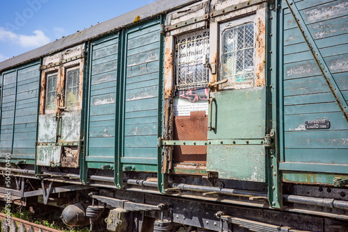Old, disused and abandoned wooden railway carriage in an old and disused railway yard