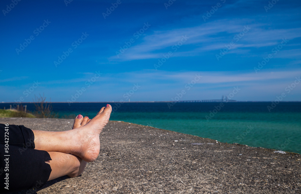 Relaxing feet and picturesque Baltic sea Relaxing feet and picturesque Baltic sea