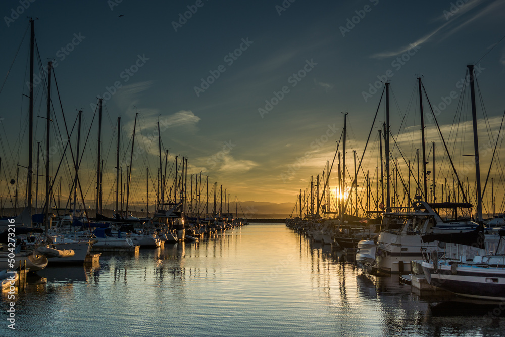 Obraz premium Sunset over ships moored at Shilshole Bay Marina, Ballard, Seattle, Washington