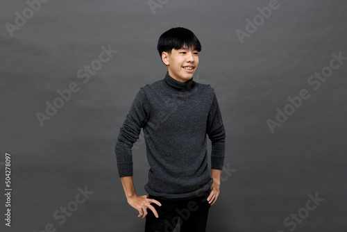 Young handsome Asian man posing at studio