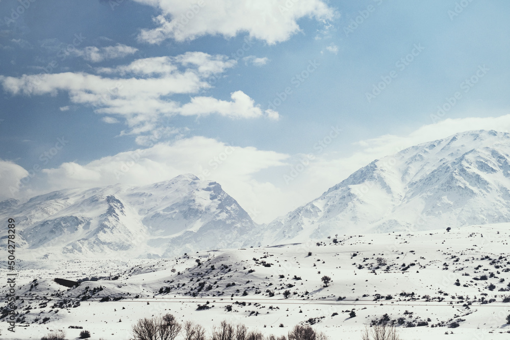 Fototapeta premium Landscape of mountains with snow and clouds