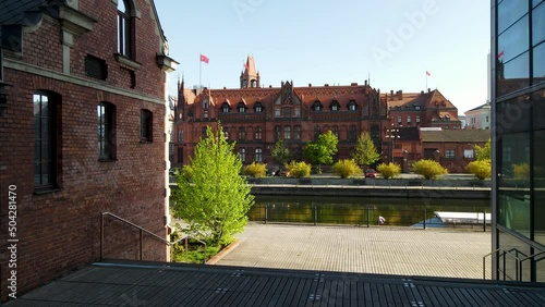 Dolly forward shot of Brda River and famous Main Post Office Building during summer - Bydgoszcz,Poland