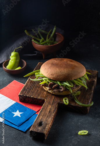 Chilean Latin american sandwich burger Chacarero with premium beef slices and green bean on black background. photo