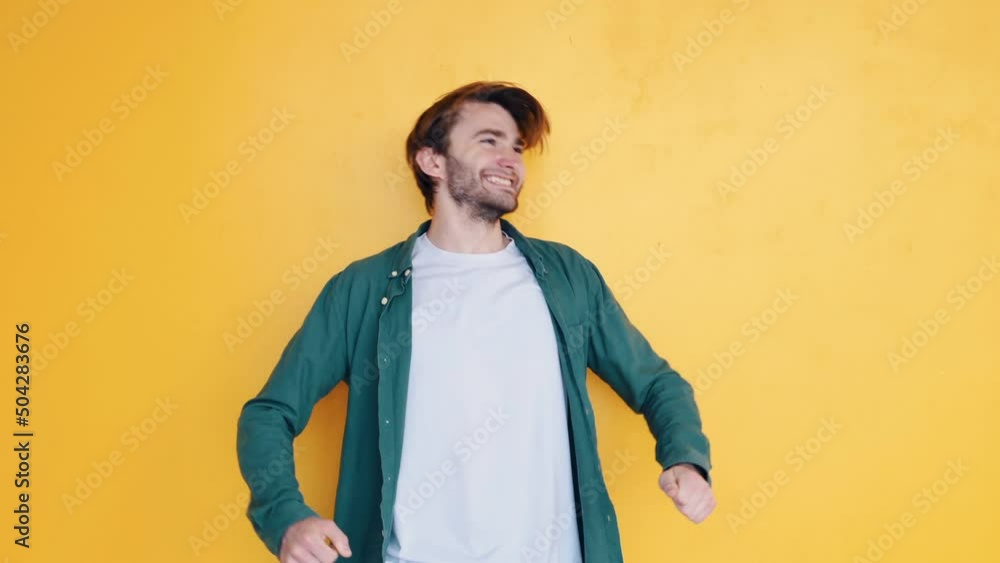 Uplifting expression. Man in casual clothes standing in the studio and showing emotions Uplifting expression. Man in casual clothes standing in the studio and showing emotions