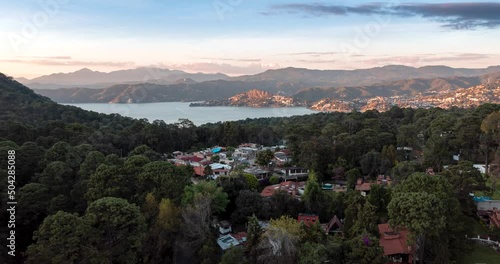 hyperlapse of low-altitude flight of the drone over Avandaro in the direction of Valle de Bravo lake at sunset photo