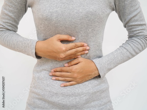 Bild auf Leinwand Gastroenteritis in an Asian woman and she experiences abdominal pain in the middle of her abdomen and position near the navel