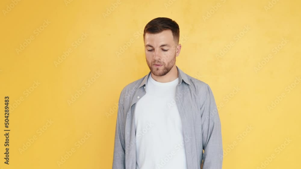 Thoughtful look. Man in casual clothes standing in the studio and showing emotions Thoughtful look. Man in casual clothes standing in the studio and showing emotions